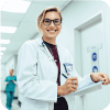 Woman doctor, smiling while holding a clipboard and pen.